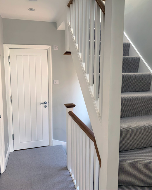 construction company in Epsom and Surrey grey and white hallway interior, white wooden bannisters